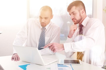 Obraz premium Portrait of Two businessmen working with laptop in the office