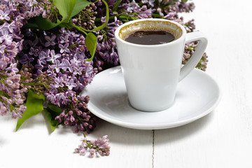 Coffee for Breakfast and lilac flowers. Selective focus