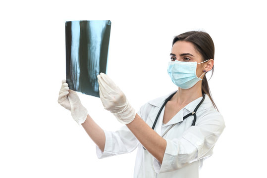 Surgeon examining patient's x-ray on white background