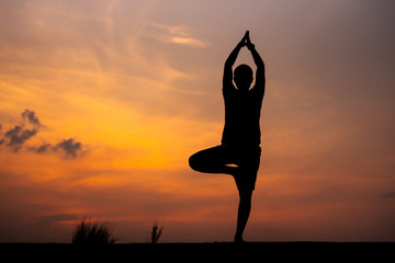 Silhouette Asia woman yoga on sunset. - Image