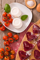 Red heart ravioli with tomato, mozzarella and basil. 