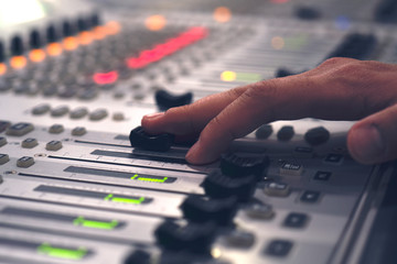 Professional audio mixing console with faders and adjusting knobs - radio / TV broadcasting