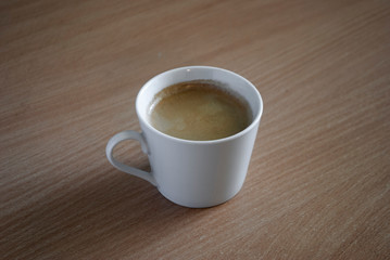 cup of coffee on wooden table