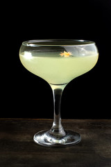 Alcoholic cocktail decorated with a beautiful yellow flower.