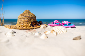 Background with vacation summer beach accessories over Baltic Sea with white sand and blue sky....