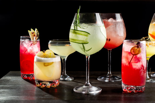 Eight alcoholic cocktails with orange slices, ice, watermelon slices, cherries, pear and cucumbers-2.