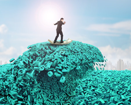 Big data driving concept. Surfing business man riding dollar bill surfboard on the tsunami wave of computer data, huge amount of numbers and letters, with sunlight sky cityscapes background.