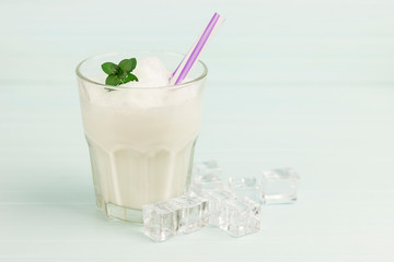 glass of milkshake with ice and mint