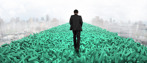 Big data highway concept, businessman walking on the road of huge amount of green letters and numbers in the air, with cloudy sky cityscapes background.