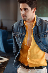 Handsome young business man posing in cafe indoors.