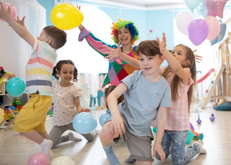 Clown at children birthday party entertaining preschool kids