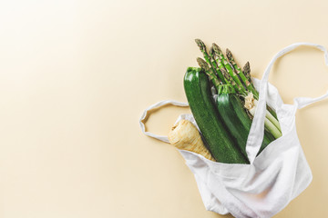 Different vegetables in textile bag on grey