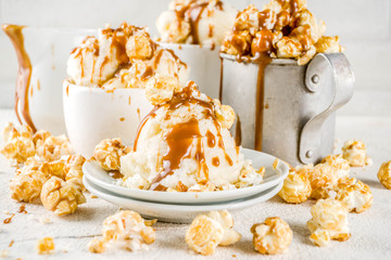 Much of homemade caramel ad pop corn ice cream, on white marble ice cream copy space