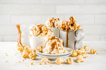 Much of homemade caramel ad pop corn ice cream, on white marble ice cream copy space