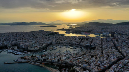 Aerial drone bird's eye view of famous port of Piraeus one of the largest in Europe at sunset with beautiful golden colours, Attica, Greece