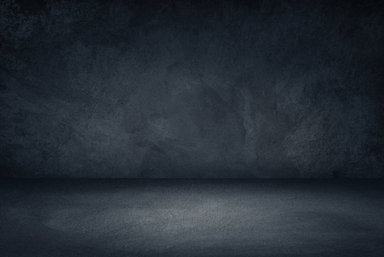 Dark black and blue grungy wall background for display or montage of product