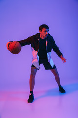 Fototapeta na wymiar Portrait of a fit sportsman playing basketball