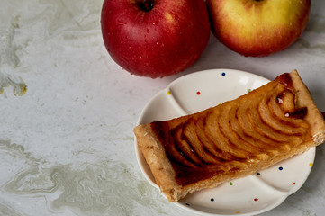 A delicious piece of Apple pie, red apples. Tea party.