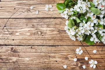 Obraz na płótnie Canvas Spring flowering branch on wooden background. Apple blossoms Copy space