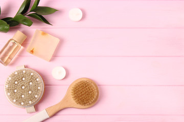 Brush for massage in the spa composition on a colored background top view. Prevention of cellulite skin care. Flatlay
