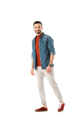 Naklejka premium handsome man in denim shirt smiling and looking at camera isolated on white