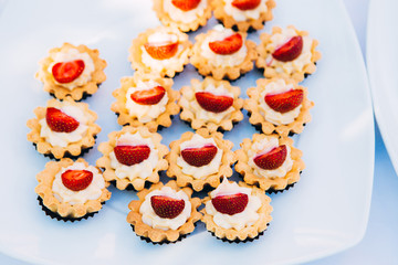 summer dessert with fruit. baskets with cream and strawberries.