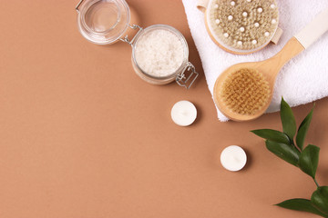 Brush for massage in the spa composition on a colored background top view. Prevention of cellulite skin care. Flatlay