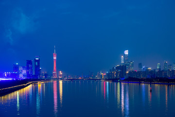 Fototapeta na wymiar Guangzhou cityscape over the Pearl River with Liede Bridge, Canton TV Tower and financial district illuminated in the evening. Guangzhou, Southern China.