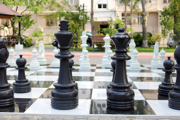 Сhessboard with large plastic figures. Large outdoor chess in the public area, Large street chess...