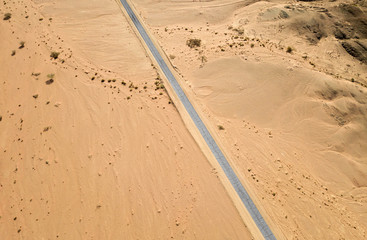 Old Desert road with cracked asphalt, Top down aerial image.