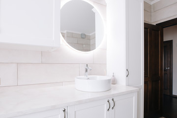 Minimalist bathroom with sink and mirror. Mirror with led backlight