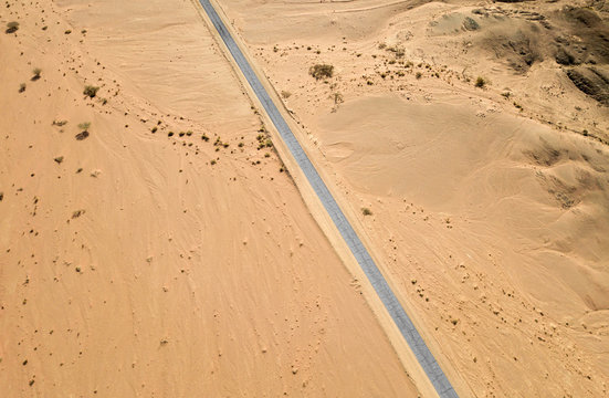 Old Desert Road With Cracked Asphalt, Top Down Aerial Image.