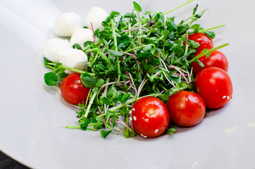 Fresh salad with chicken breast, arugula and tomato.