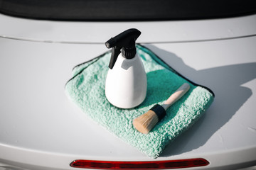 Spray, tassel with microfibre cloth at the trunk of car