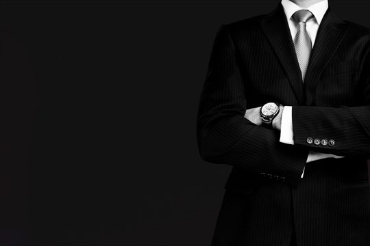 Businessman with hand watch on background, close-up