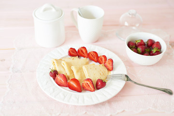 pancakes with strawberries on the table on a white background