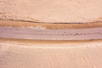 Old Desert road with cracked asphalt, Top down aerial image.