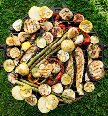 Grilled vegetables on the barbecue plate, top view, outdoors. Vegan food