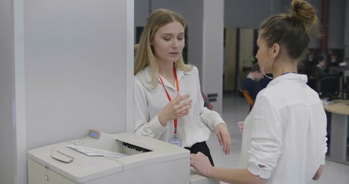 Business people talking in office by the scanner machine