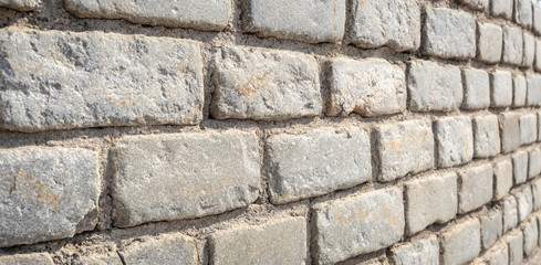 Stone wall. Stony blocks texture. Grey  stone rock wall. Wall of gray stones bonded with cement. 