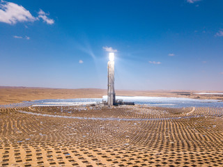 Solar power tower and mirrors that focus the sun's rays upon a collector tower to produce...