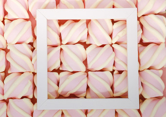 Creative colored pink marshmallows background. Flatley from the favorite dessert of children.
