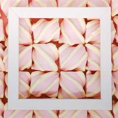 Creative colored pink marshmallows background. Flatley from the favorite dessert of children.