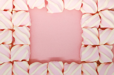 Creative colored pink marshmallows background. Flatley from the favorite dessert of children.