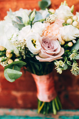 bouquet on the brick wall background. bouquet with peonies and succulents.