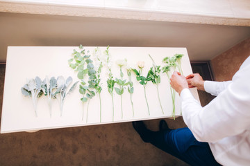 men's hands collect a bouquet. Florist's work.