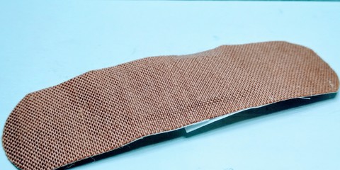 Strip of adhesive bandage plaster on white background