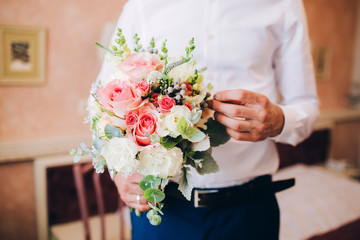 men's hands collect a bouquet. Florist's work.