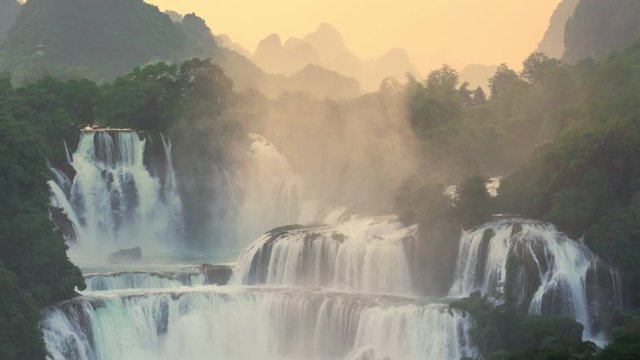 Sunset Bangioc waterfall in Vietnam and Detian waterfall in China, located near border, people can see this waterfall both of country. , Zoom out.