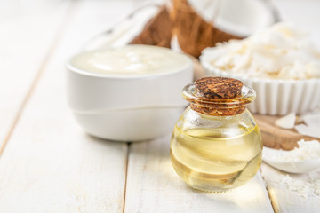 MCT coconut oil concept - coconuts, butter and oil on wood background, copy space